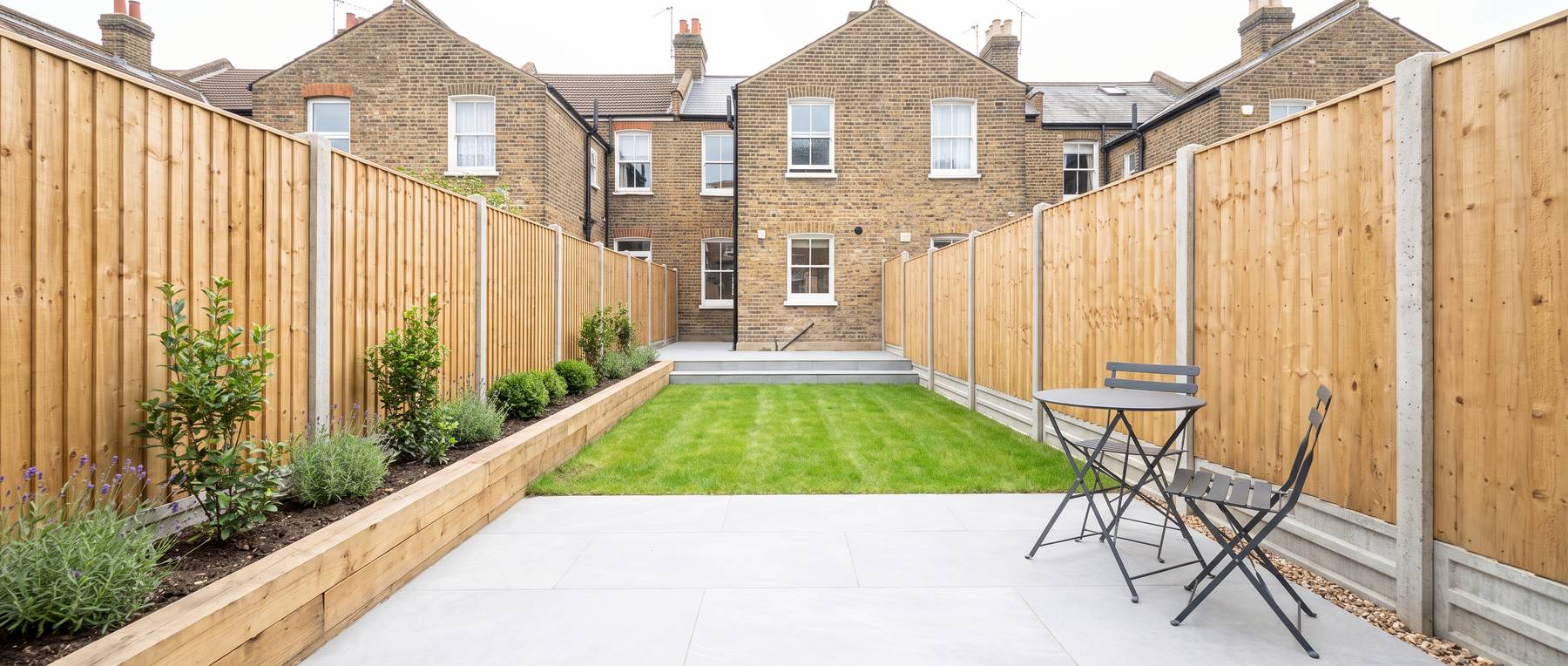 A newly landscaped London garden with a porcelain patio, lawn, raised bed and featheredge fencing